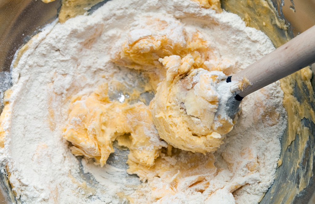 Creamy cookie dough being mixed in a bowl with flour and butter – Yummy Cooking Treats