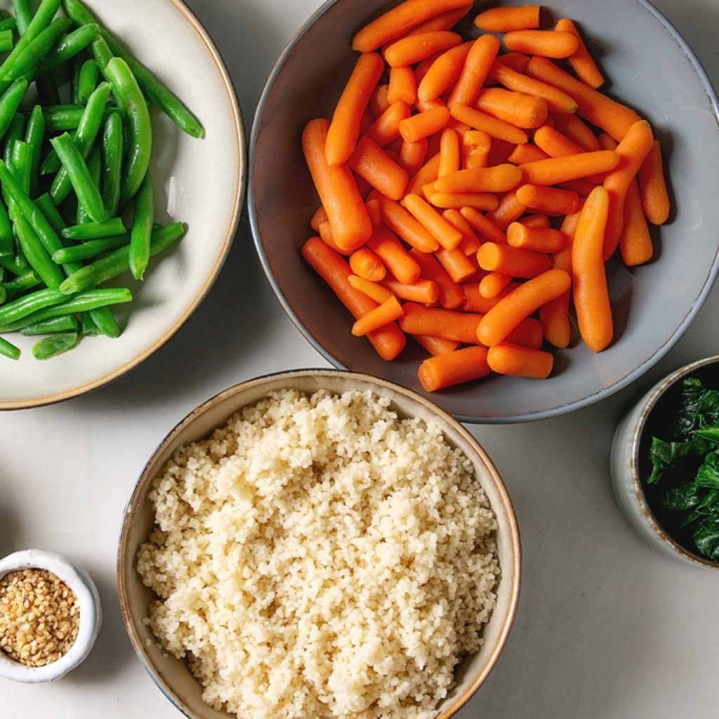 Bowl of fresh fried rice ingredients—green beans, carrots, corn, spinach, couscous, sesame oil—perfect for quick meals | Yummy Cooking Treats