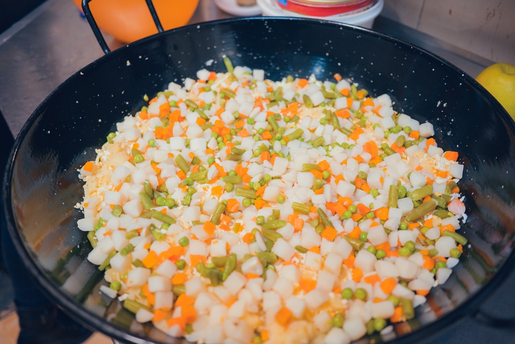 Colorful mix of diced carrots, potatoes, peas, and green beans in a wok—perfect vegetable base for fried rice by Yummy Cooking Treats